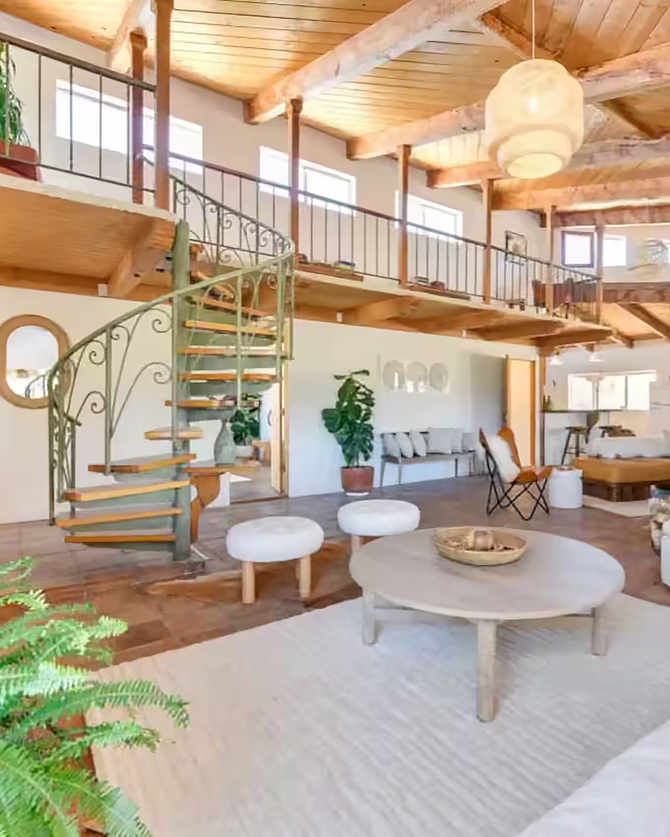 Spacious retreat interior with spiral staircase and natural light